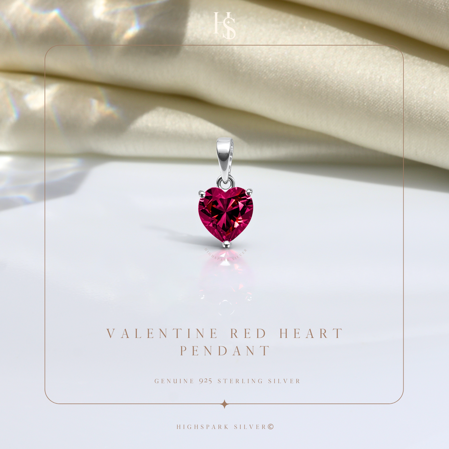 A sterling silver pendant with a faceted, heart-shaped red stone in a three-prong setting.