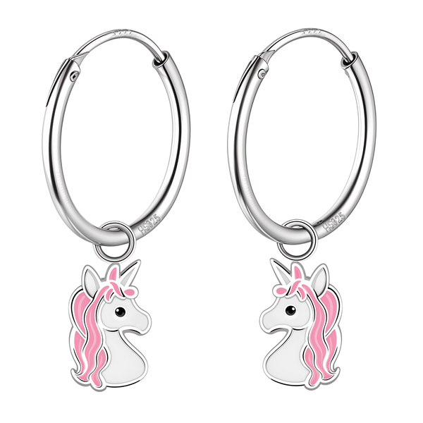 A pair of sterling silver unicorn hoops feature dangling charms of a unicorn head with pink and white enamel, shown on a white background.