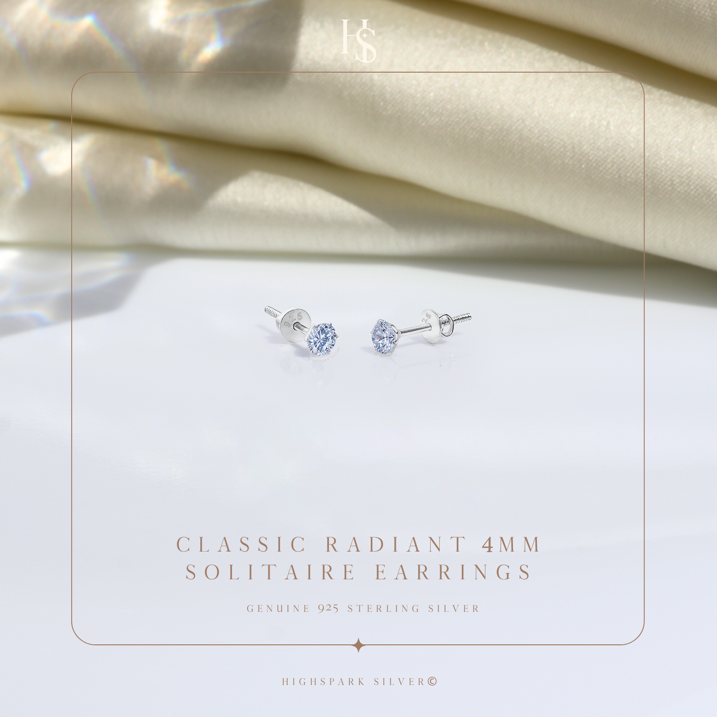 A pair of sterling silver stud earrings with round American diamonds in a four-prong setting.