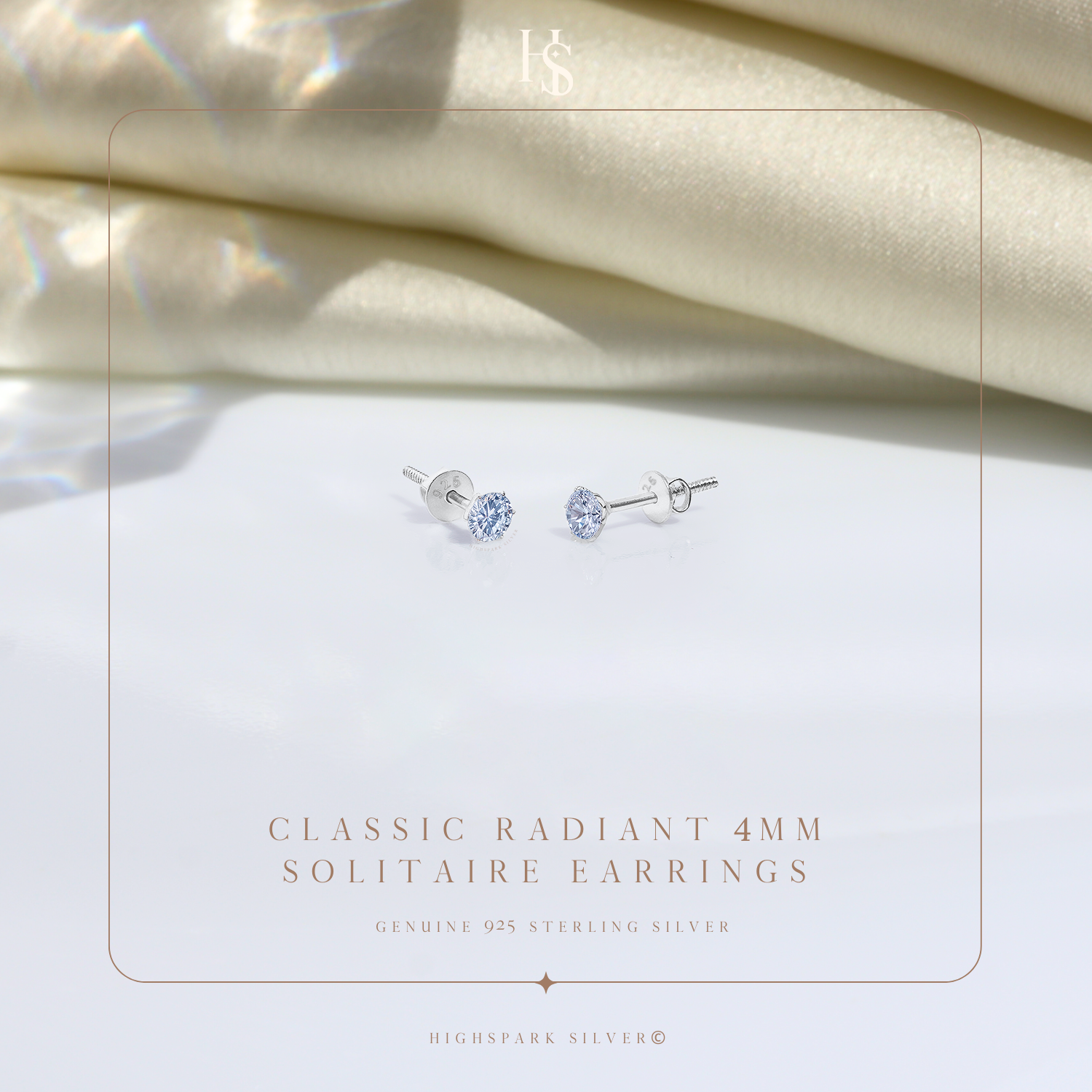 A pair of sterling silver stud earrings with round American diamonds in a four-prong setting.