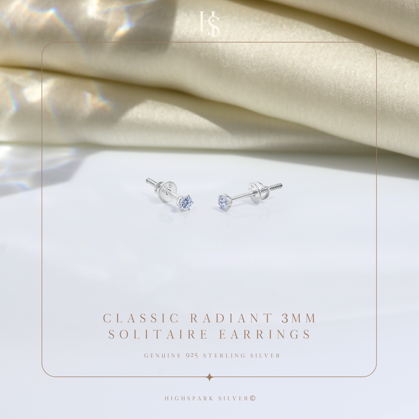 A pair of sterling silver solitaire stud earrings with round American diamonds in a four-prong setting and screw backs.