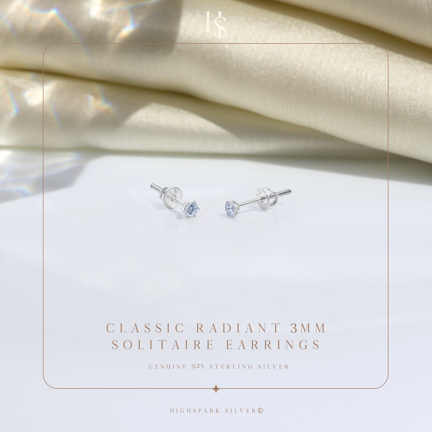 A pair of sterling silver solitaire stud earrings with round American diamonds in a four-prong setting and screw backs.