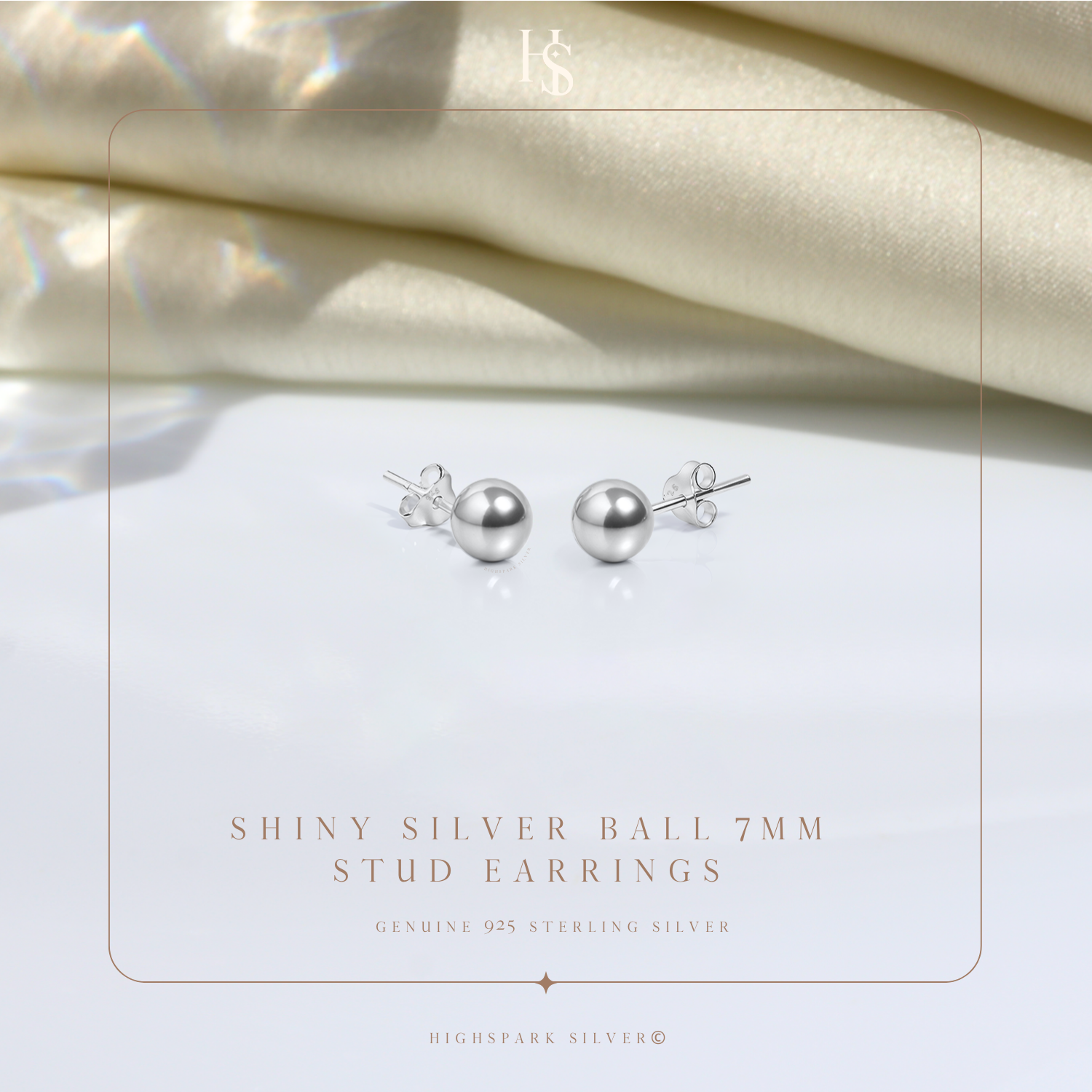 A pair of shiny sterling silver ball stud earrings with butterfly backs.