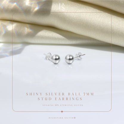 A pair of shiny sterling silver ball stud earrings with butterfly backs.