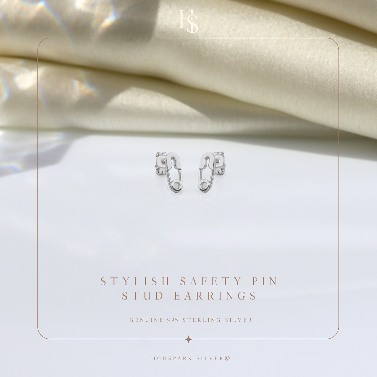 Silver safety pin earrings on a HighSpark card – minimal pin studs, actual size