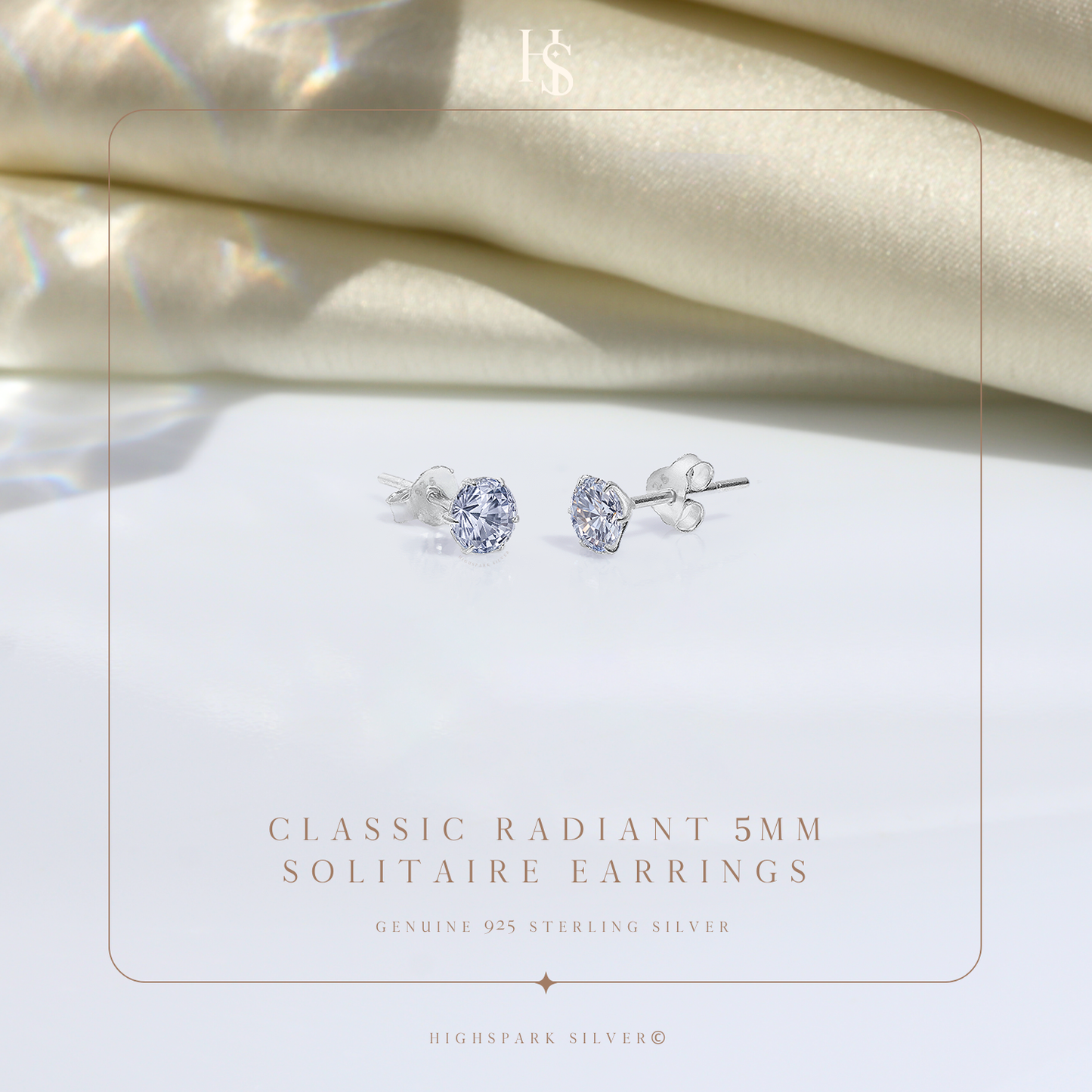 A pair of sterling silver stud earrings with round American diamond solitaires in a six-prong setting.