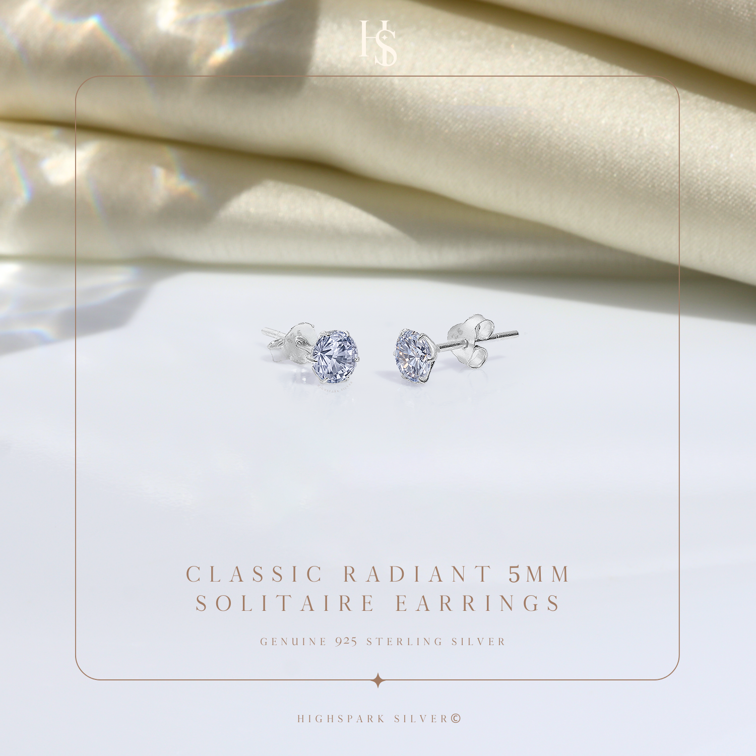 A pair of sterling silver stud earrings with round American diamond solitaires in a six-prong setting.
