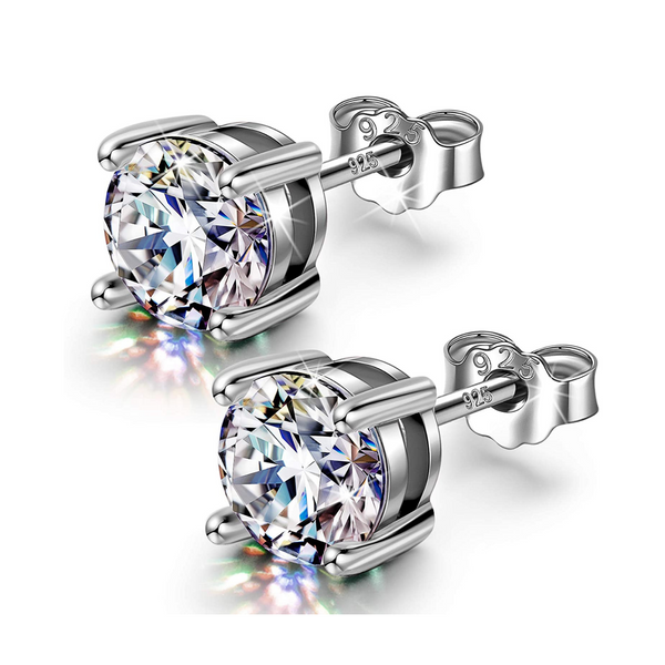 A pair of classic solitaire stud earrings for men, featuring round American diamonds in a four-prong setting of polished 925 sterling.