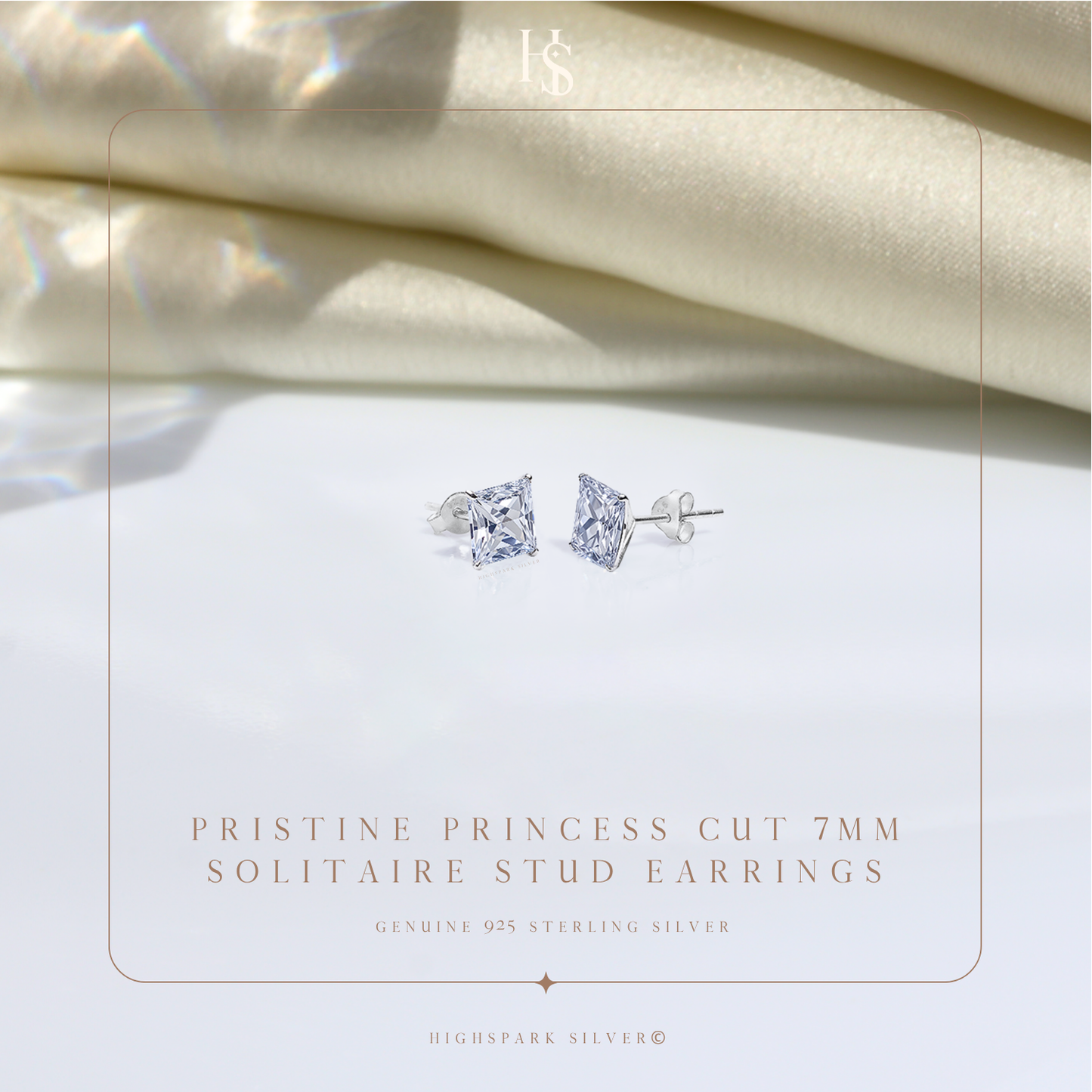 A pair of sterling silver stud earrings with princess-cut American diamonds in a four-prong setting.