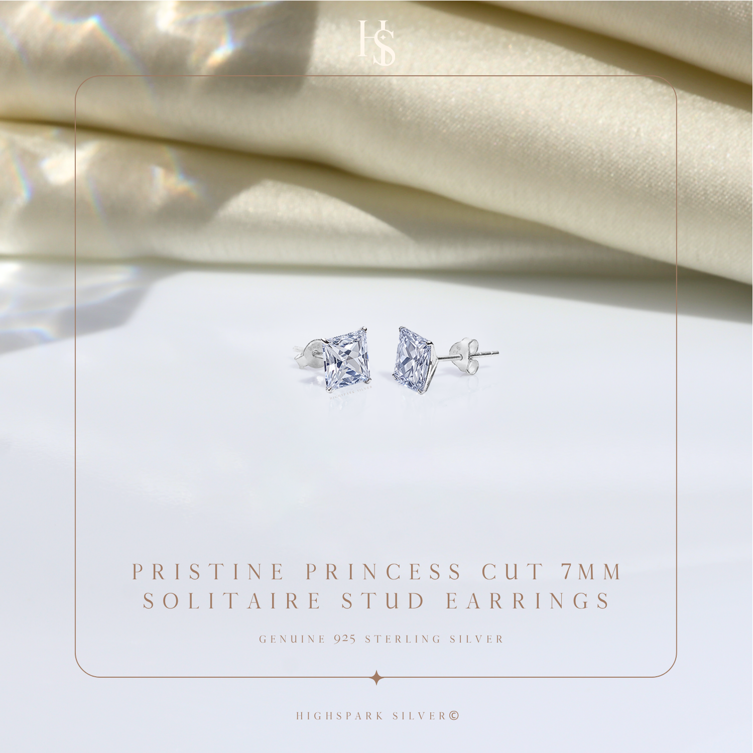 A pair of sterling silver stud earrings with princess-cut American diamonds in a four-prong setting.
