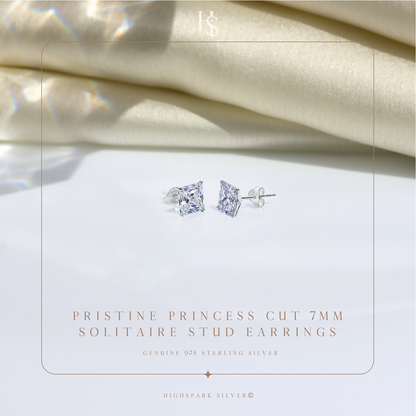 A pair of sterling silver stud earrings with princess-cut American diamonds in a four-prong setting.