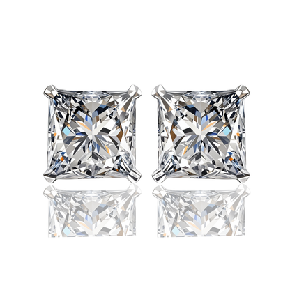 A pair of solitaire stud earrings with princess-cut American diamonds in a four-prong sterling silver setting on a white background.