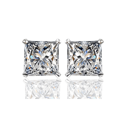 A pair of stud earrings with princess-cut American diamonds in a four-prong sterling silver setting, shown on a white reflective surface.