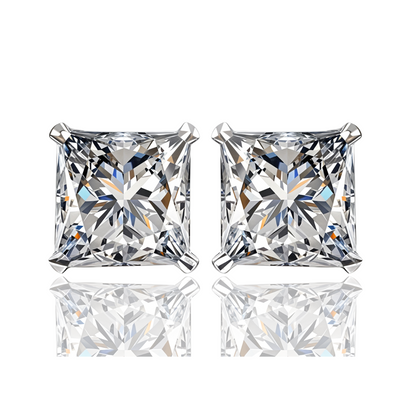 A pair of solitaire stud earrings with princess-cut American diamonds in a four-prong sterling silver setting.