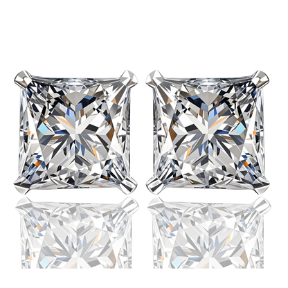A pair of stud earrings with princess-cut American diamonds in a four-prong sterling silver setting, shown on a white reflective surface.