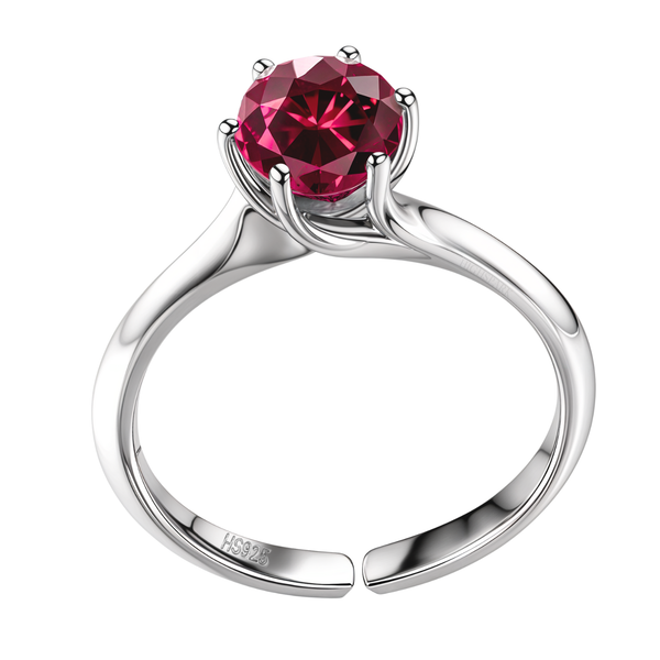 An adjustable sterling silver solitaire ring with a round-cut ruby American Diamond held in a six-prong setting on a plain white background.