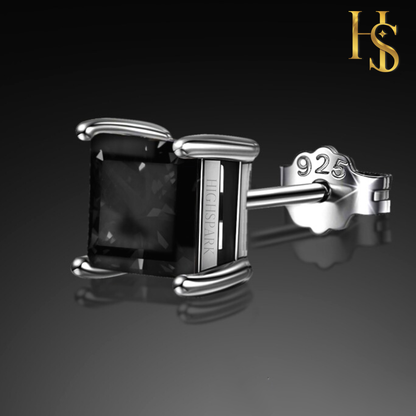 A single stud earring with a square-cut black stone in a four-prong sterling silver setting.