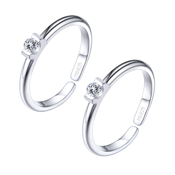 A pair of adjustable sterling silver toe rings, each featuring a single round American diamond in a tension setting, on a white background.