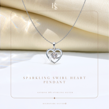 A sterling silver pendant necklace with an open heart and a central round American diamond, styled on draped cream satin fabric.