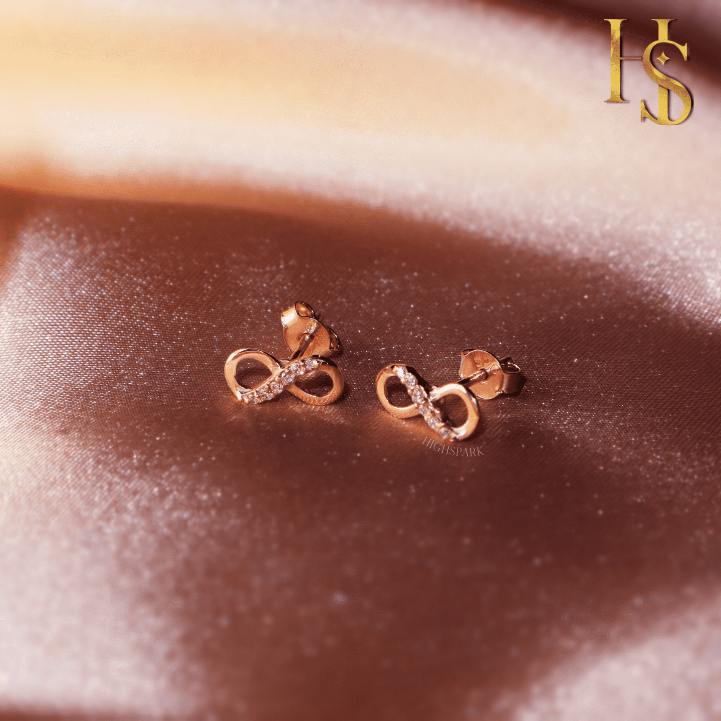 Rose Gold Infinity Stud Earrings in 92.5 Silver studded with Swiss Zirconia - 18K Rose Gold finish