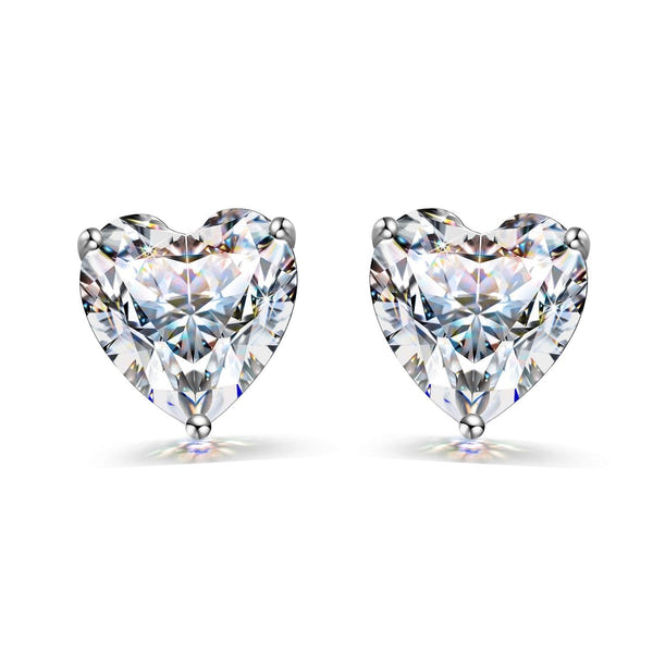 A pair of stud earrings with heart-shaped American diamonds in a three-prong sterling silver setting on a white background.