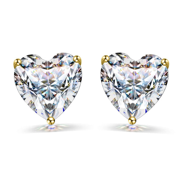 A pair of stud earrings with heart-shaped American diamond solitaires in a three-prong gold-plated setting on a white background.