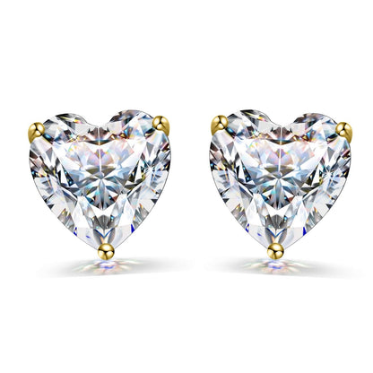 A pair of stud earrings with heart-shaped American diamond solitaires in a three-prong gold-plated setting on a white background.