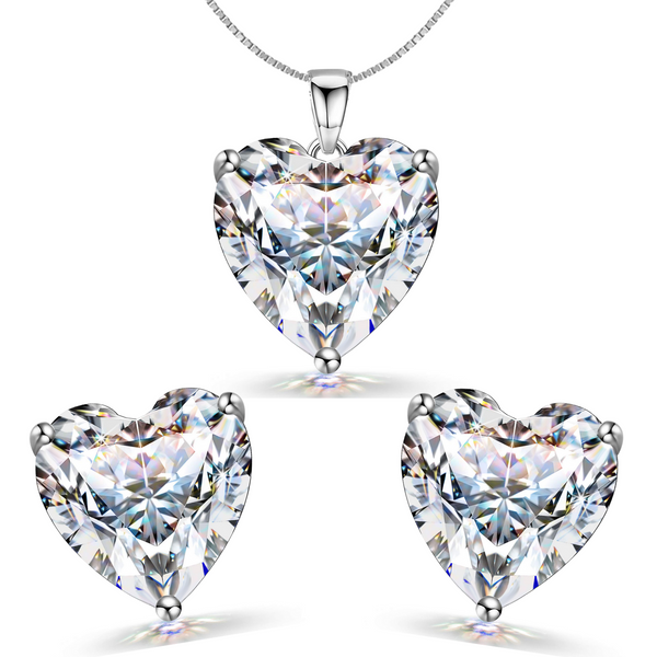 A sterling silver jewellery set with a heart-shaped American diamond pendant necklace and matching three-prong stud earrings on a white.
